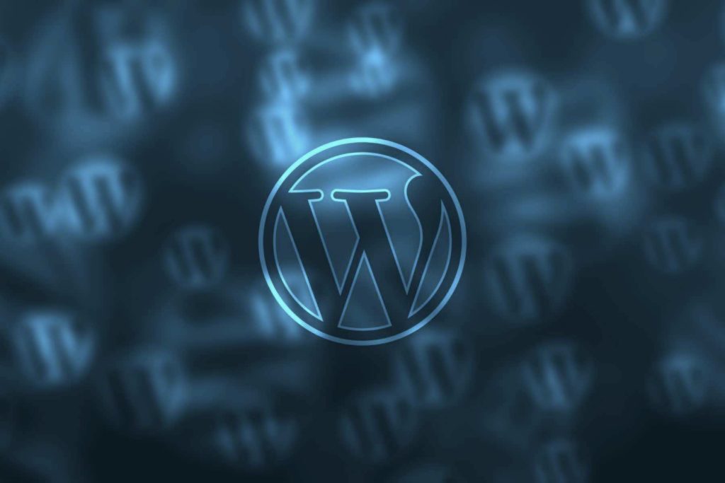 A wordpress logo illuminated against a backdrop with multiple blurred wordpress symbols, symbolizing studio anansi's website strategy prowess.