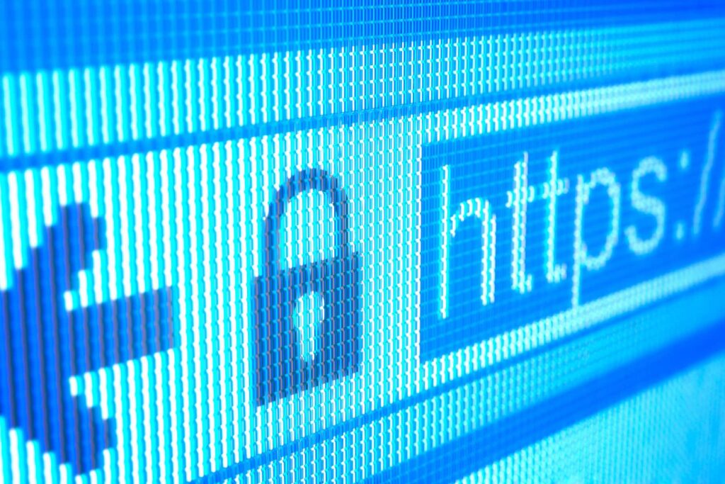 Close-up of a digital screen displaying an https url with a padlock icon, symbolizing website design and internet security.