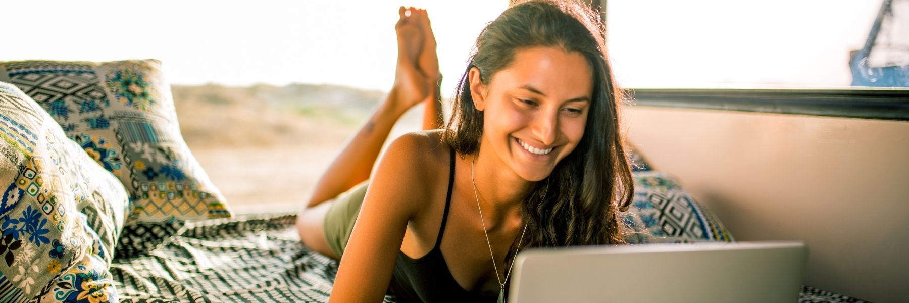 Smiling woman typing on laptop