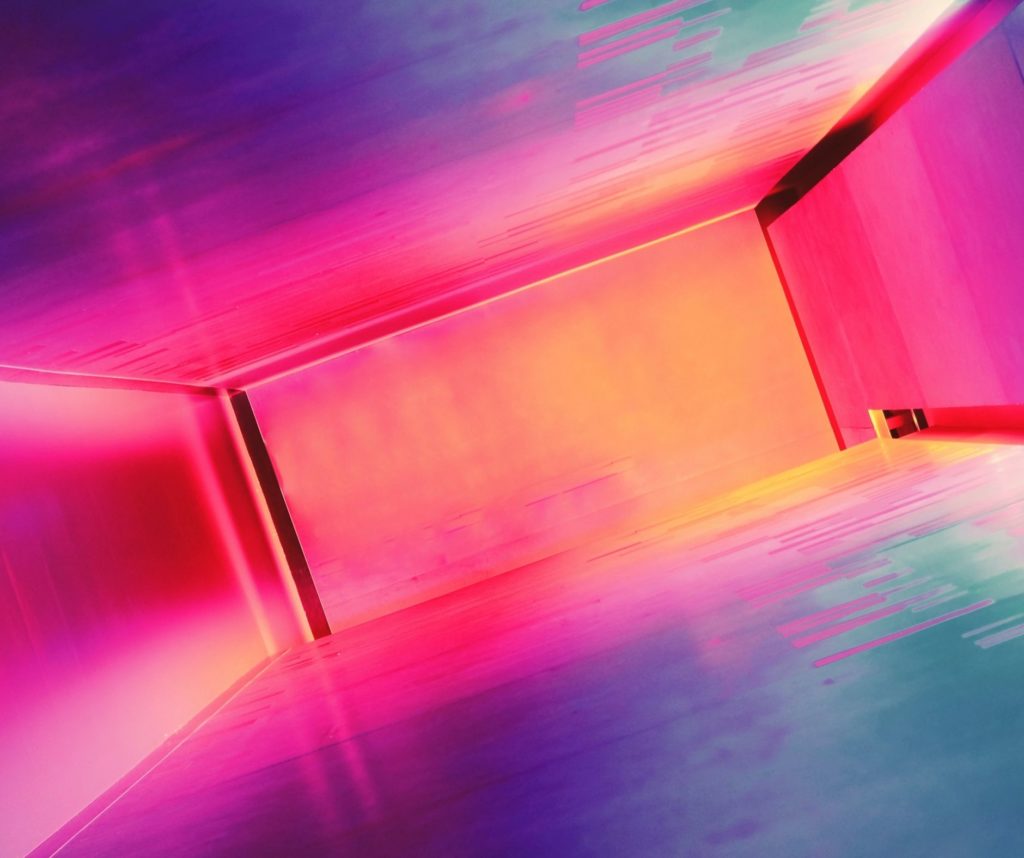 Colorful abstract corridor with pink and orange neon lights, designed by studio anansi in portland, oregon.